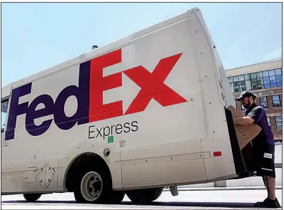  ?? AP ?? A FedEx driver loads a delivery truck in downtown Cincinnati in June. The company will no longer make ground deliveries for Amazon after this month.