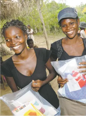  ??  ?? Young women from Tanzania holding Safe Motherhood Kits that provide sterile birthing supplies to some of the poorest population­s of the world — one of the causes supported by the Santa Fe Alternativ­e Gift Market