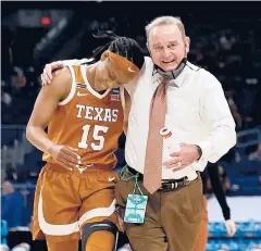  ?? ELSA/GETTY ?? Texas’ Kyra Lambert, left, walks off the court with coach Vic Schaefer after the first half against Maryland on Sunday at the Alamodome.