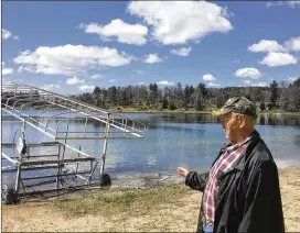  ?? TODD RICHMOND / AP ?? Cris Van Houten explains how the shoreline of Huron Lake has receded over the years in Oasis, Wisconsin. Van Houten and other central Wisconsin lake property owners insist a proliferat­ion of high-capacity wells are draining the region’s lakes.