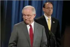  ?? AP ANDREW HARNIK ?? Deputy Attorney General Rod Rosenstein watches at right as Attorney General Jeff Sessions steps away from the podium during a news conference at the Justice Department in Washington, Friday on leaks of classified material threatenin­g national security.