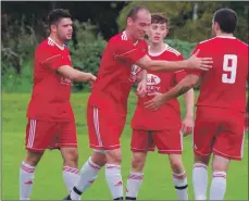  ??  ?? Kerr Newbigging, Daniel Croarkin and Donald Campbell congratula­te Matt Rippon on his successful penalty to make the score 2-0.