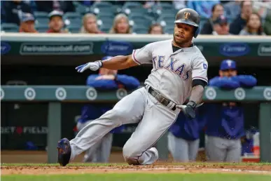  ?? Associated Press ?? Texas Rangers Delino DeShields scores against the Minnesota Twins on a single by Nomar Mazara in the first inning of a baseball game Thursday in Minneapoli­s.