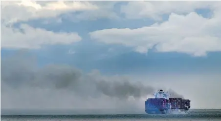  ?? DARREN STONE, TIMES COLONIST ?? The cargo ship Zim Kingston burns near Constance Bank in the Strait of Juan de Fuca on Saturday.