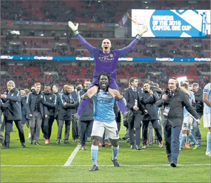 ??  ?? THAT’S THE WAY TO DO IT: Wilfried Bony hoists keeper Willy Caballero aloft after City’s dramatic penalty shoot-out win
