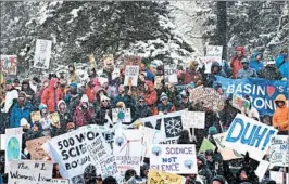  ?? JASON CONNOLLY/GETTY-AFP ?? Snow didn’t deter marchers in Denver. Protesters in the U.S. also endured rain and heat.