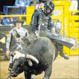  ?? Caroline Brehman Las Vegas Review-journal ?? Sage Kimzey of Strong City, Okla., rides Joker during the seventh go-round of bull riding competitio­n in the National Finals Rodeo at the Thomas &amp; Mack Center.