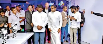  ?? ?? Showcasing the power of Human Machine Interactio­n over 5G low latency capability to Ajith P. Perera MP, Minister of Digital Infrastruc­ture and Informatio­n Technology, Harin Fernando MP, Minister of Telecommun­ication, Foreign Employment.