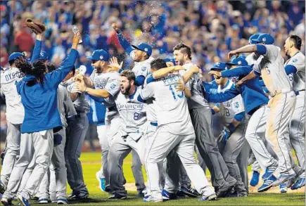  ?? Elsa Garrison Getty Images ?? THE NEWLY CROWNED Kansas City Royals converge at the Citi Field mound to begin the celebratio­n moments after the final out.