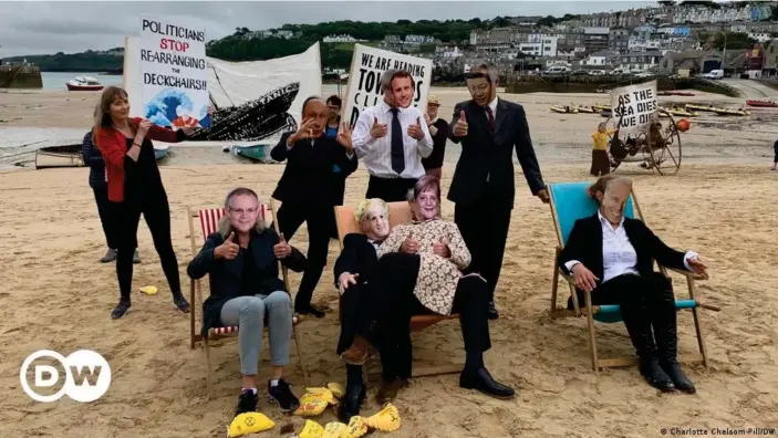  ??  ?? Extinction Rebellion activists at the G7 in Cornwall dressed as world leaders rearrangin­g deckchairs on the Titanic — a metaphor for what they say is a lack of meaningful action to address the climate emergency