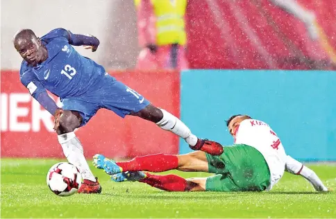  ?? — AFP photo ?? France's defender N'golo Kante (L) fights for the ball with Bulgaria's midfielder Georgi Kostadinov during the FIFA World Cup 2018 qualifying football match between Bulgaria and France at The Vasil Levski Stadium in Sofia on October 7, 2017.