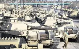  ?? CHRISTIAN MURCOCK The Gazette via AP | Nov. 29, 2016 ?? A soldier walks past M1 Abrams tanks at Fort Carson in Colorado Springs, Colo. It could take months or years for the tanks to be delivered to Ukraine.