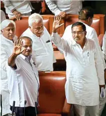  ?? PTI ?? Karnataka CM H D Kumaraswam­y with his deputy G Parameshwa­ra and other JD(S) and Congress leaders wave to the media on Friday