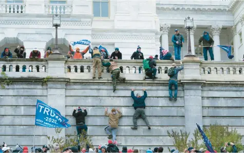  ?? JOSE LUIS MAGANA/AP ?? Supporters of then President Donald Trump climb the west wall of the the U.S. Capitol in Washington on Jan. 6, 2021.