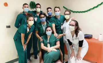  ?? UHealth ?? Nurse Lauren Caldevilla, seated, is a University of Miami nurse educator who took on training medical staff in the COVID unit at the beginning of the pandemic. The first critical care graduation of nurses selected was in August 2020. UM nurse educator Diana Levy designed the UHealth residency program in five weeks.