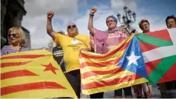  ??  ?? Protesters carry Esteladas, Catalan separatist flags, and Basque flags, during a rally in favour of a referendum on independen­ce from Spain Reuters