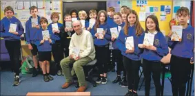  ?? ?? Author Kenneth Steven with pupils from Lochnell Primary School; and below, childminde­r Maureen Maitland with a young charge in the reading room.