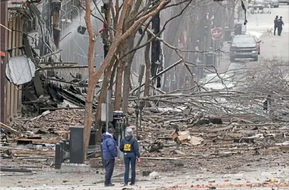  ?? Mark Humphrey/Associated Press ?? Emergency personnel work near the scene of an explosion Friday in downtown Nashville, Tenn.. Buildings shook in the immediate area and beyond after a loud boom was heard early Christmas morning.