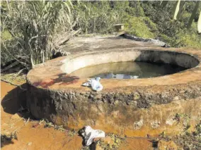  ?? (Photos: Donicka Robinson) ?? The water tank at the centre of a dispute which left one man dead and a policeman hospitalis­ed following a clash in D’acre, St Ann, yesterday.