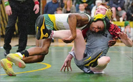  ?? DANA JENSEN/THE DAY ?? New London’s Naaji Powell-Keyton attempts to take Fitch’s Aiden Robertson to his back during their 113 pound match on Monday night at Conway Gymnasium. Powell-Keyton earned a 14-7 decision as the Whalers defeated the Falcons 57-24. New London also...