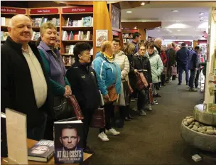  ??  ?? Mary Kennedy from Camolin has her copy of the book signed by the man himself. Above: the queue at the launch in Wexford’s Book Centre.