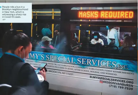  ?? AFP ?? People ride a bus in a Brooklyn neighbourh­ood in New York, which is witnessing a sharp rise in Covid-19 cases.