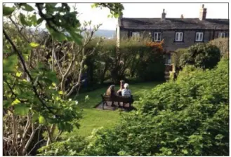  ??  ?? Price’s mom and English aunt sit together in her garden in Huddersfie­ld, Yorkshire — a chance to relax and chat in person that had been in the making for 30 years.