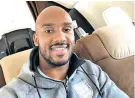  ??  ?? Happy return: Fabian Delph on flight back after the birth of his daughter