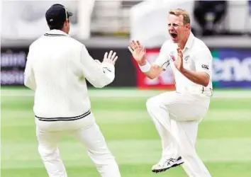  ?? AFP ?? What a set-up! Neil Wagner (right) of New Zealand celebrates the dismissal of Sri Lanka skipper Angelo Mathews with teammate Ross Taylor during day five of the first Test in Dunedin yesterday.