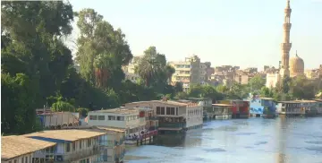  ??  ?? Houseboats line the Nile bank in Cairo. Some 85 million Egyptians depend on the Nile for water. According to the United Nations, Egypt is currently below the UN’s threshold of water poverty. — IPS photo by Cam McGrath