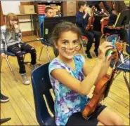  ?? CAROL HARPER — THE MORNING JOURNAL ?? Makayla Mercado wears whiskers for a drama and ties a karate belt on a violin during a practice session of Lorain Arts Academy at New Beginnings Academy at 307 W. 7th St. in Lorain. Each color belt shows a student mastered a challenge on the violin.
