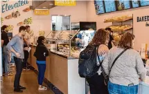  ?? ?? Customers line up to place orders during the lunch rush at Bread Zeppelin.