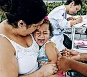  ?? ANDRE PENNER/AP ?? A child cries out as she is given a vaccine against yellow fever at a health post set up near Sao Paulo, Brazil.