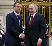  ?? ALEXANDER ZEMLIANICH­ENKO, THE ASSOCIATED PRESS ?? Russian President Vladimir Putin, right, is welcomed by French President Emmanuel Macron at the Palace of Versailles, near Paris.