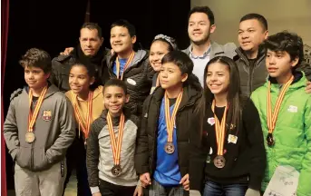  ??  ?? Above right: The students not only attend football training and competitio­ns, they also learn skills to protect themselves in sports and cope
with frustratio­n in the winter camp.
Right: The students pose for a photo after receiving awards at the...