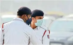  ??  ?? Traffic policemen wear masks to protect themselves as air quality deteriorat­es, in New Delhi