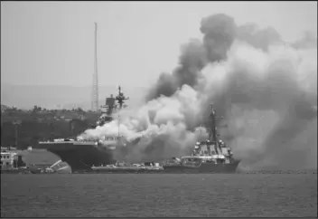  ?? DENIS POROY/AP ?? Smoke rises from the USS Bonhomme Richard at Naval Base San Diego Sunday, in San Diego after an explosion and fire Sunday on board the ship at Naval Base San Diego.