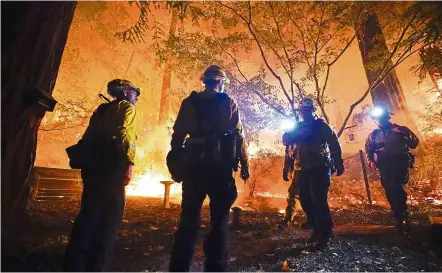  ??  ?? Keeping watch: Firefighte­rs monitoring the blaze in Boulder Creek, California. — AP