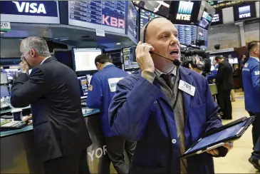  ?? RICHARD DREW / ASSOCIATED PRESS ?? Trader Daniel Leporin works on the floor of the New York Stock Exchange on Wednesday, a day when the Dow Jones industrial average lost 372 points, or 1.8 percent, to close at 20,606 on news of continued upheaval in the Trump White House.