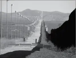  ?? KENNETH MADSEN VIA AP ?? IN THIS NOV. 15, 2016, PHOTO PROVIDED BY KENNETH MADSEN, stadium lights atop tall poles oversee a pedestrian barrier stretching for miles along a section of the border wall between Douglas, Arizona, and Agua Prieta, in the Mexican state of Sonora.