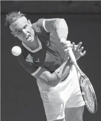  ?? ANDY BROWNBILL/AP ?? Rafael Nadal serves during his quarterfin­al win over Denis Shapovalov at the Australian Open on Tuesday.