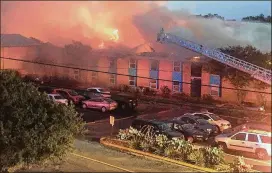  ?? CONTRIBUTE­D BY JUAN GOMEZ ?? Firefighte­rs battle a fire July 20 at the Iconic Village apartments in San Marcos. All five bodies were found in Building 500, which took the heaviest damage.