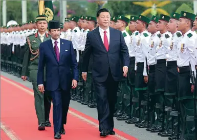  ?? JU PENG / XINHUA ?? President Xi Jinping is accompanie­d by Bruneian Sultan Hassanal Bolkiah at a welcoming ceremony on Monday in Brunei’s capital, Bandar Seri Begawan, during his state visit to the country.