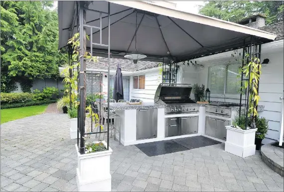  ?? WAYNE LEIDENFROS­T/PNG FILES ?? Outdoor kitchens and entertainm­ent areas, like this one in West Vancouver, are becoming increasing­ly popular among those wanting to upgrade their homes, notes Shell Busey, who adds people are looking to less costly changes that still add value.