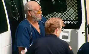  ??  ?? Facing the music: An officer escorting Bradley from a prisoners van before appearing briefly in federal court. — Reuters