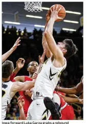  ?? MATTHEW HOLST / GETTY IMAGES ?? Iowa forward Luka Garza grabs a rebound Saturday against visiting Ohio State. Garza had a game-high 16 points and added four rebounds for the Hawkeyes.