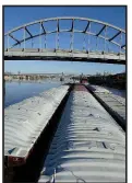 ?? Arkansas Democrat-Gazette archive photo ?? The tug Victoriapu­shes 12 barges under the old Broadway Bridge on the Arkansas River in Little Rock.