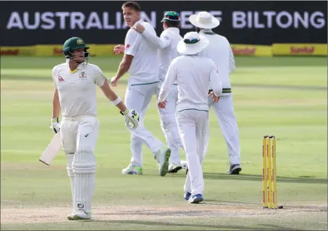  ?? Picture: MIKE HUTCHINGS, REUTERS ?? DISGRACED AND BEATEN: Steve Smith heads back to the dressing room after being dismissed by Morne Morkel (who is smiling in the background) at Newlands yesterday.