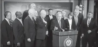  ?? TOM BRENNER / THE NEW YORK TIMES ?? Senate Majority Leader Mitch Mcconnell, R-KY., speaks alongside fellow Republican­s after the passage of their tax bill early Saturday in Washington. Mcconnell waved off any deficit concerns. “I’m totally confident this is a revenue-neutral bill,” he...