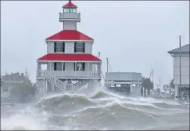  ?? REUTERS ?? Waves crash against a lighthouse in New Orleans, US, on Sunday.